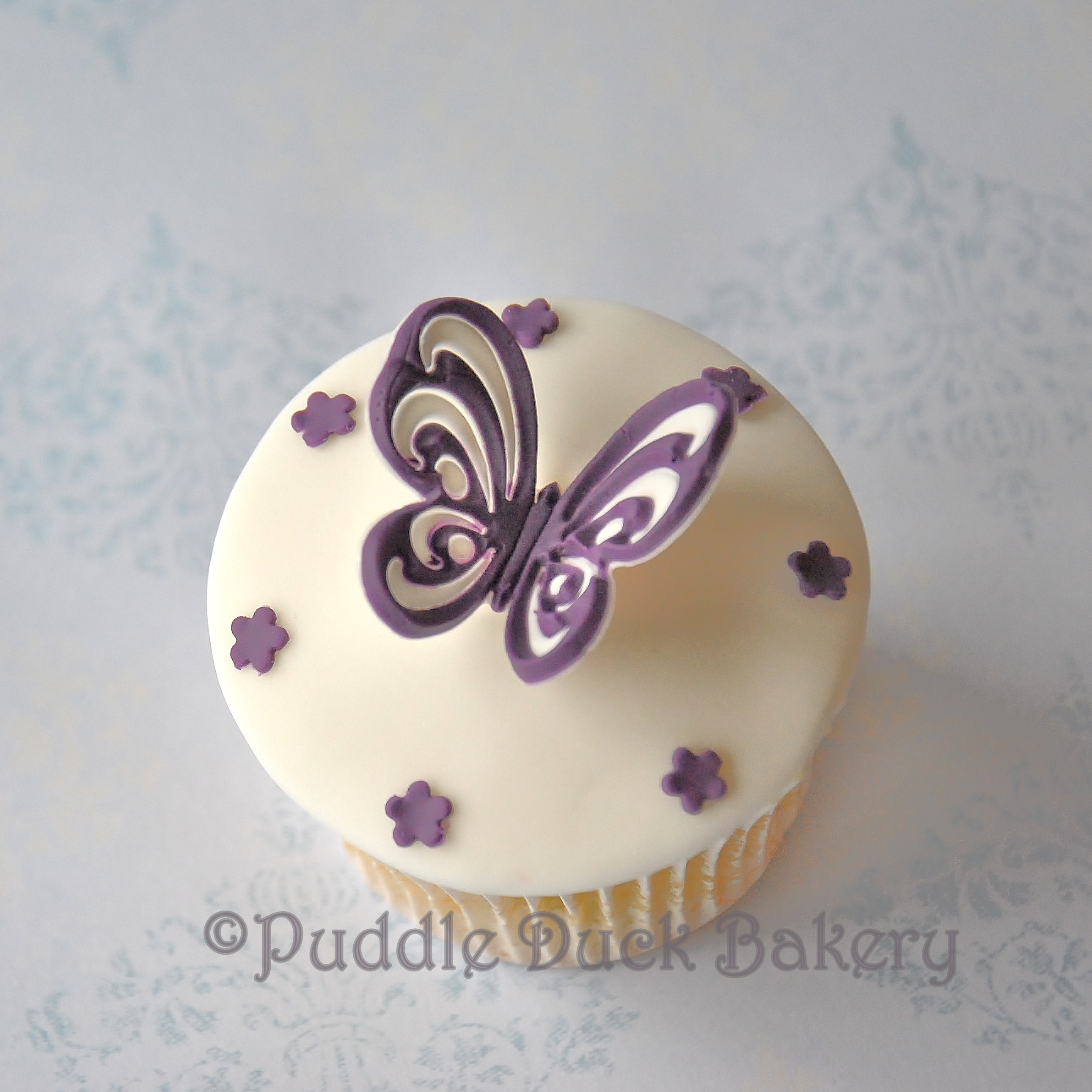 A butterfly with stars on a cupcake