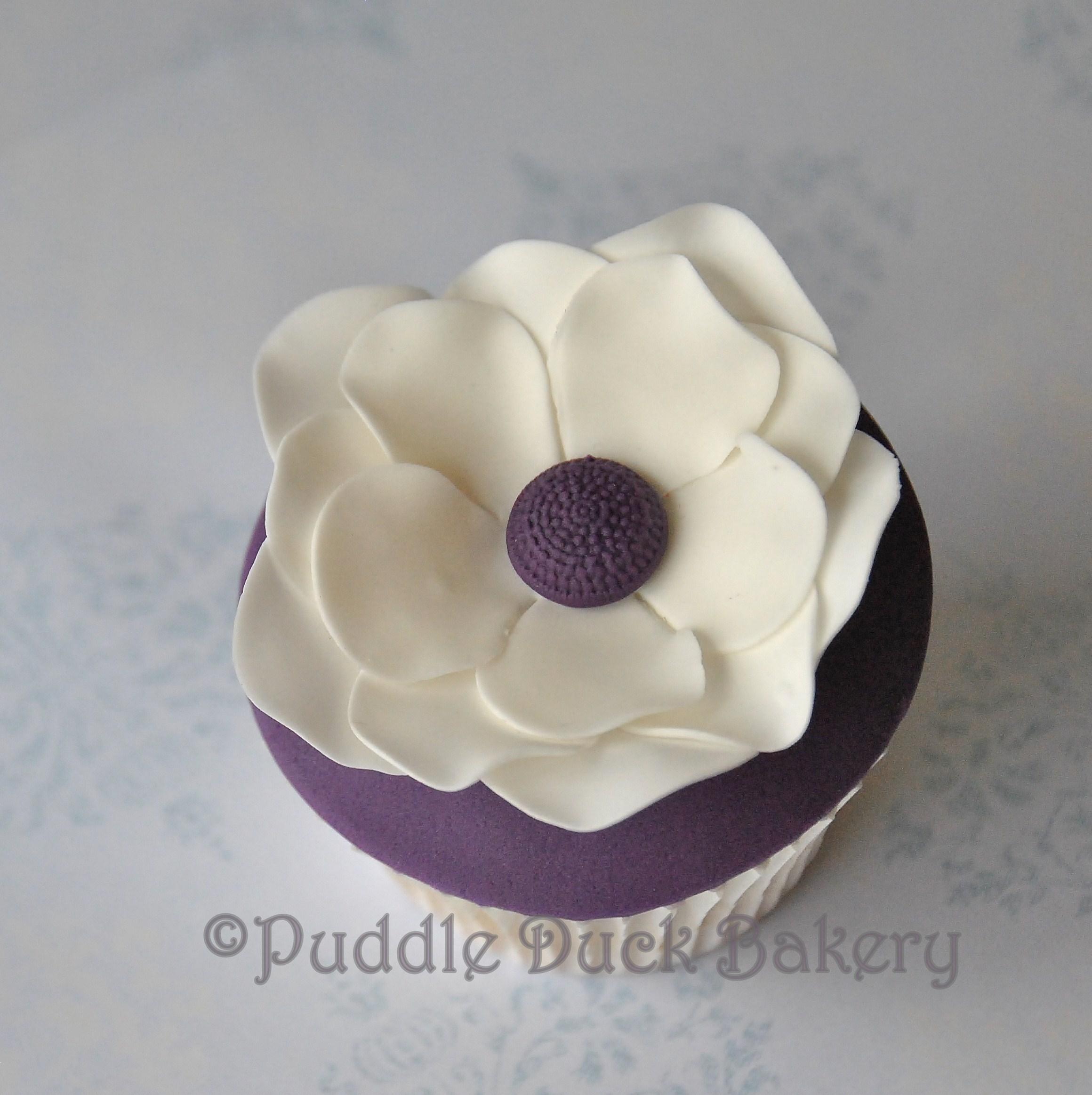 A beautiful flower with delicate petals on a cupcake.