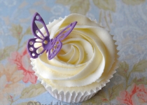 A purple butterfly on a cupcake