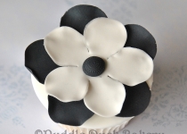 A black and white flower on a cupcake